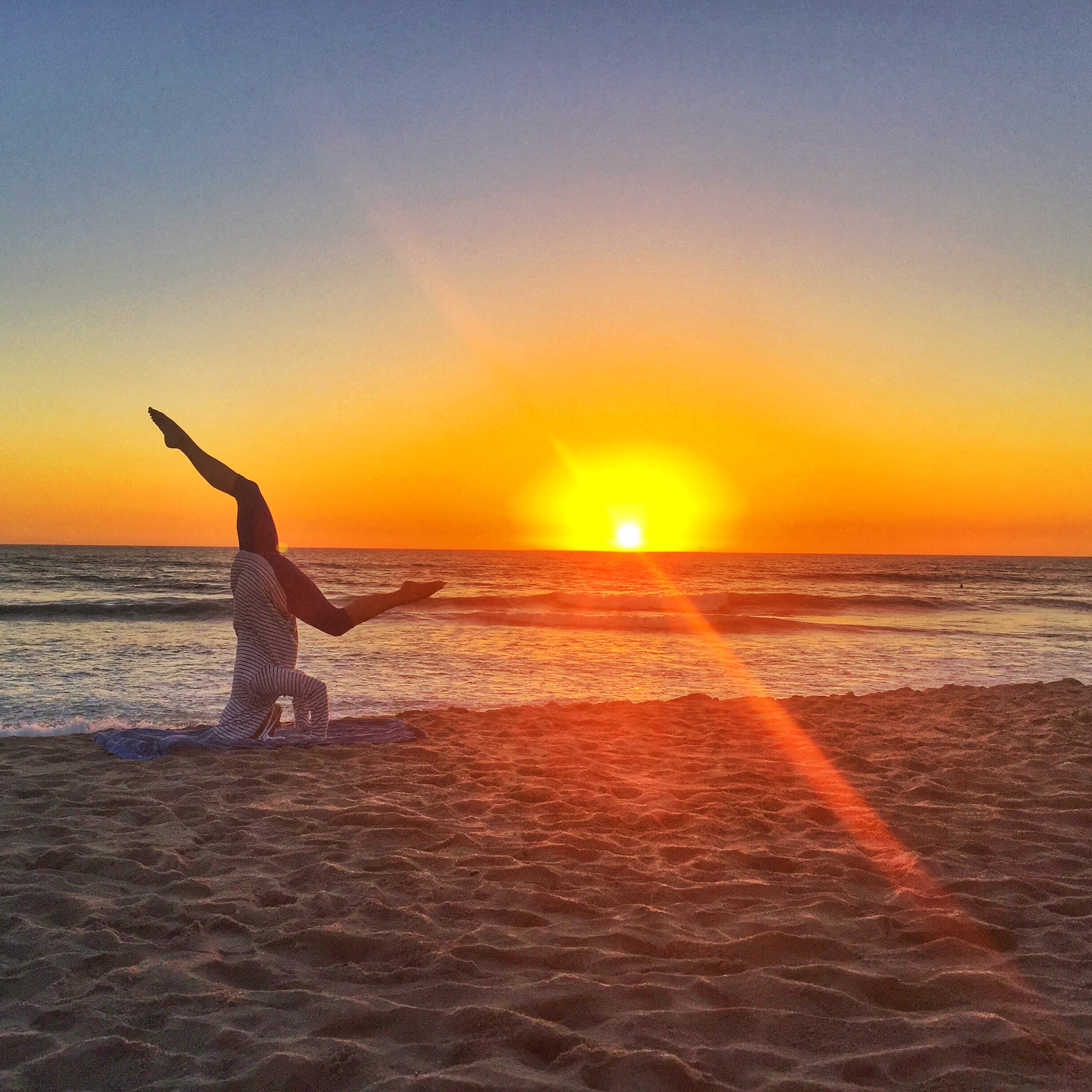 headstand play at sunset